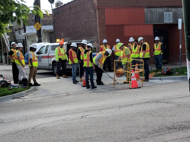 This seems like a lot of of workers to open a manhole