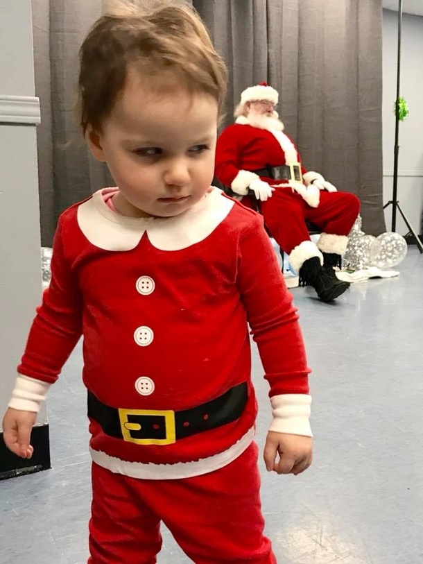 We dressed up our  month old daughter to see Santa She was not pleased