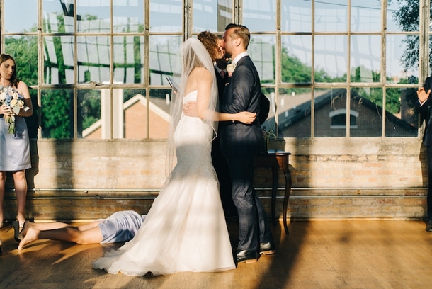 Wedding photographer captures romantic moment between bridesmaid and floor
