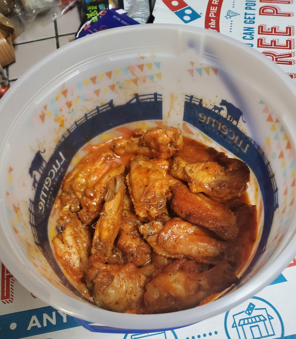Went into the kitchen to my roommate eating Buffalo wings out of an ice cream container