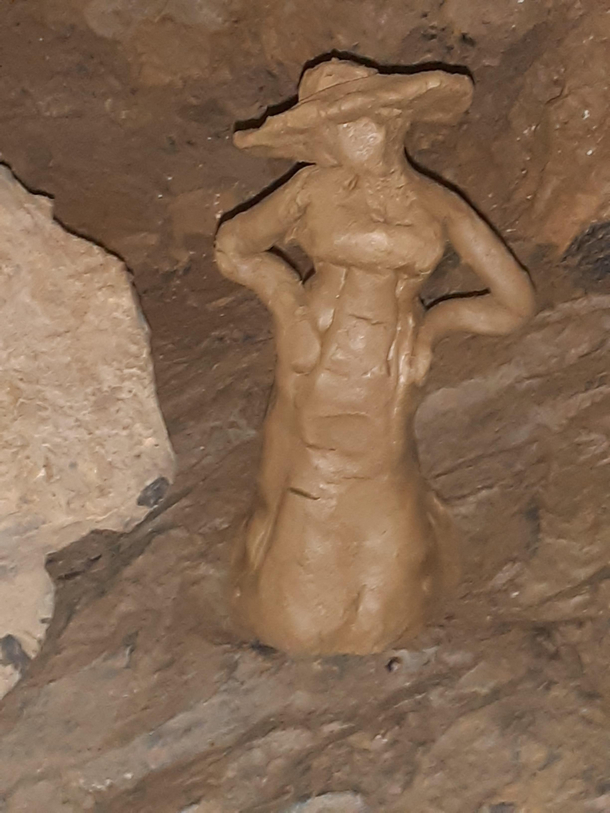 Went to a cavern and someone made a Lady Dimitrescu out of clay from the cave