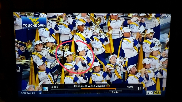 west virginia band member pretends to play trumpeteats sandwich instead