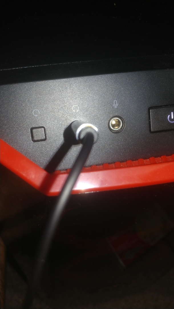 What kind of sick fck puts a button that restarts my computer right next to the headphone jack