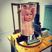 A baby getting an X-Ray looks hilarious