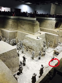 A Chinese tourist dropped his phone into the Terracotta Worriors when trying to find a good viewpoint