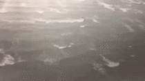 A kite surfer captured surfing the winds of Tropical Cyclone Debbie off the Australian coast
