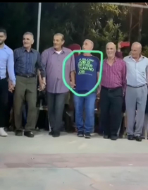 A middle eastern guy celebrating the COVID- pandemic with fellow guys with an interesting shirt that nobody knew what it meant