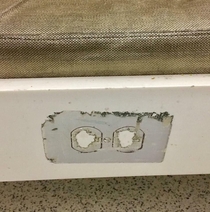 A power socket sticker at the airport