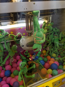 A worker in an arcade tied kermit to a claw machine