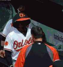 Adam Jones walking through the dugout with the Oriole Birds hat 