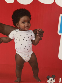 Baby has the diaper on over the onesie on the diaper box I dont recommend this method