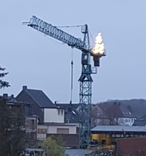 Builder put up a Christmas tree on the building crane Germany 
