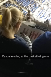 Casual reading at the ball game Maybe her man doesnt have ball game