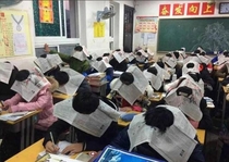 Chinese middle schoolers take exams wearing high-tech anti-cheating hats