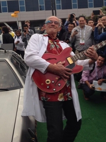 Christopher Lloyd next to a DeLorean wearing Google Glass and playing Marty McFlys Gibson from CES yesterday