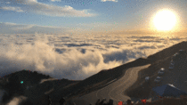 Clouds crashing into pikes peak like waves in the ocean