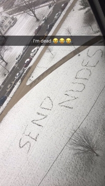 College student tries to take advantage of the first snow next to a dorm