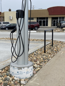 Electric car charging station and hitching post side by side