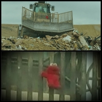 Elmo strapped to the front of a landfill bulldozer