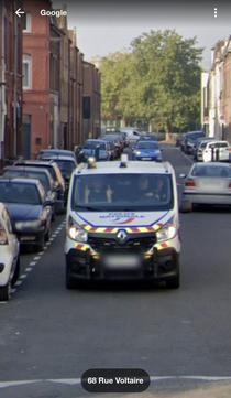 French cop showing his little fingers to a google street car