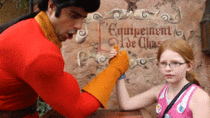 Girl at Disneyworld challenges Gaston to an arm wresting contest