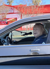 Guy and Mic stand in Car