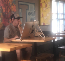 Guy at coffee shop shows off his solution to the  Apple stand