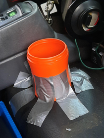 Guys at work duct taped a coffee canister to the center console because theres no cup holder in the truck lol