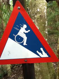 I found this sign in South Africa Yeah maybe it is not a good idea to push a person on a wheelchair towards crocodile on a hill