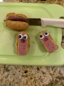 I have to cut mini corn dogs in half for my son for his dinner These two didnt appreciate the show