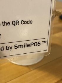 I read this as Smile Piece of Shit