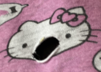 I tore a hole in my Hello Kitty pajamas and it perfectly made a mouth going bleurgh