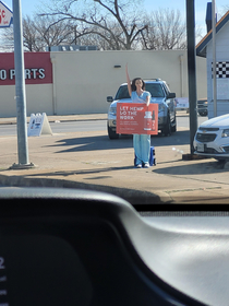 I was at a stop light and I avoided making eye contact with her for a couple minutes Because I didnt understand why her hand was up Then I realized I was avoiding eye contact with this