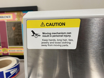 I was looking at this warning sign on a postage machine at work trying to figure out why itd warn having a bird on the equipment Oh