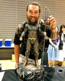 Jason Mamoa having fun with his action figure