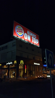 Just a Burger Kind ad on top of a McDonalds restaurant