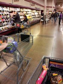 Just a grown adult riding in a shopping cart while her mother shops