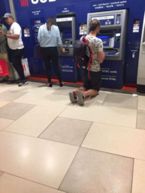 Just a tall tourist using an ATM in South East Asia