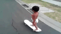Just a toddler riding a skakeboard