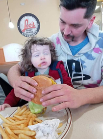 Kid has his first burger at a coney