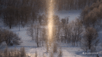 Light shines through snowfall