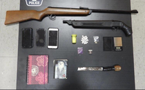 Local police in high-end very safe city showing off their drug bust Pellet guns  convenience store scale pink note book tiny amount of unidentified drugs Cell phones
