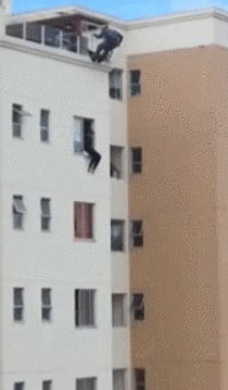 Man preparing to jump off building is kicked back into window