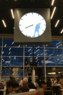 Man writes the clock in Schiphol Airport Amsterdam