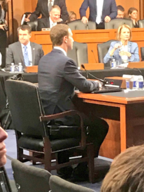 Mark Zuckerburg sitting on a booster seat