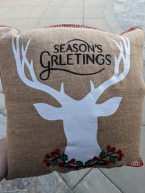 Mom was showing off her new pillow with a manufacturer error SEASONS GRLETINGS EVERYONE