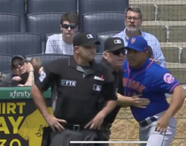 Mother in the background of todays MetsPirates game giving her child earmuffs while Mets manager Luis Rojas shouted expletives at the home plate umpire