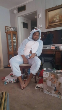 My brother-in-law who has  girls taking in the aftermath of Christmas morning wearing a Yeti Onesie that they picked out for him