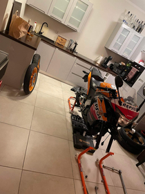 My buddy is keeping his bike in the kitchen