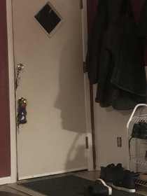 My coat created a shadow face on my door that looks strangely like my mother